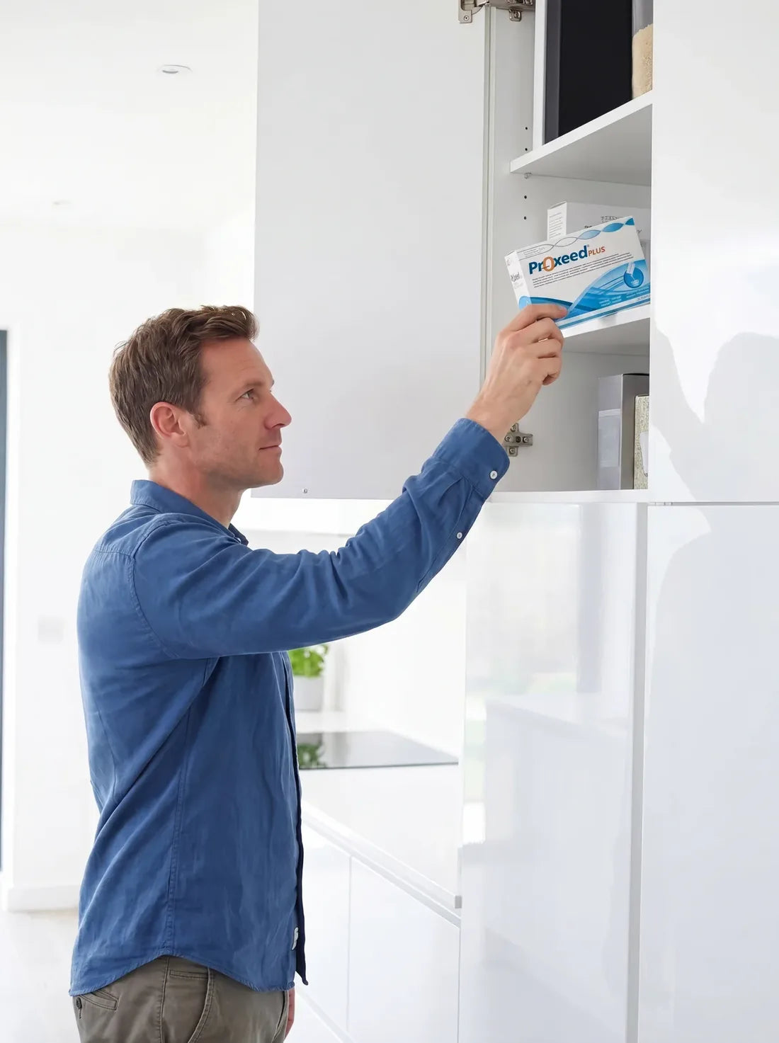 Reaching for Proxeed Plus in the kitchen cupboard